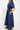 Side view of model wearing East Bennu Navy Dress