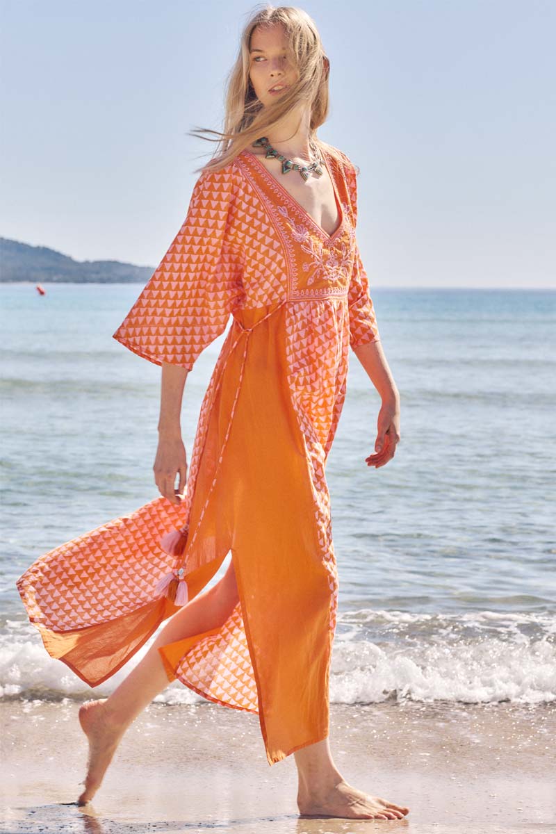 Side view of model walking on the beach wearing East Mirabelle Kaftan