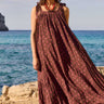 Full length of model wearing East Paola Spot Sleeveless Dress by the sea