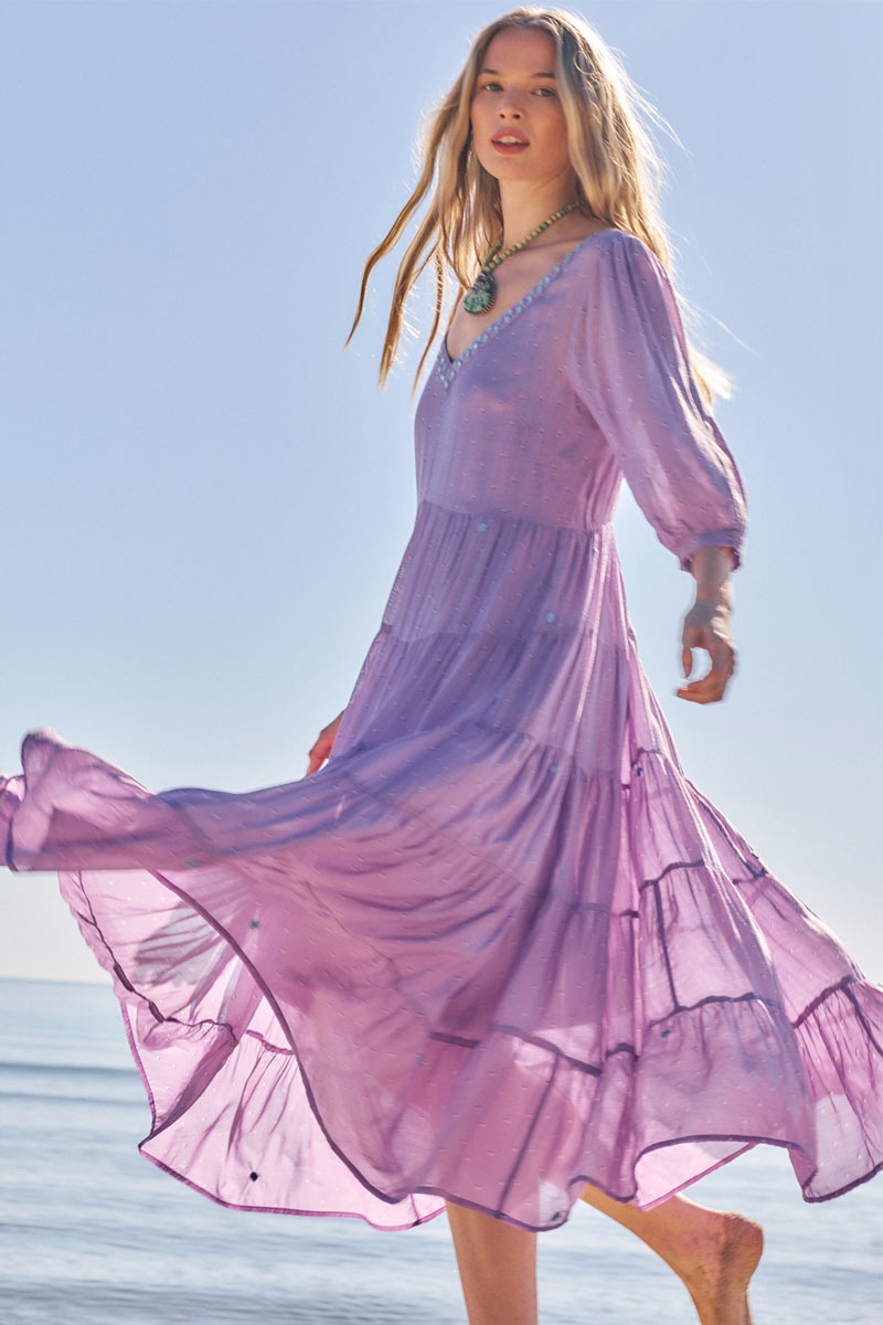 Side view of model wearing East Malia Dress on the beach