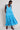 Model wears East Fleur Blue Spot Dress