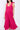 Model wears East Fleur Pink Spot Dress